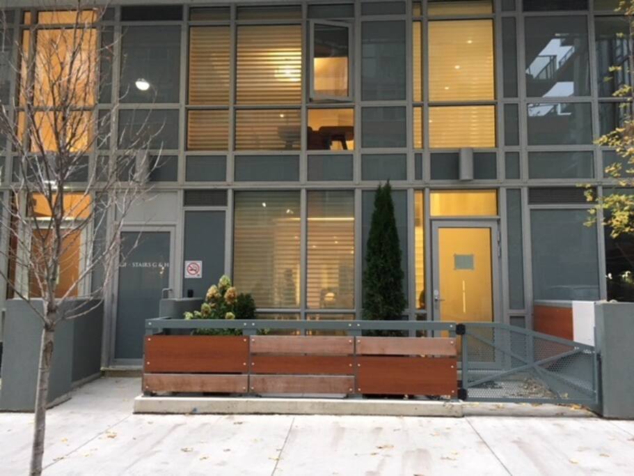 Front of 2-story townhouse. Private patio. Direct street access; no need to wait for elevator!