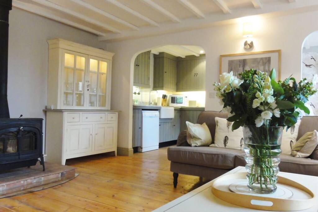 Delightful open plan living area with large wood-burner