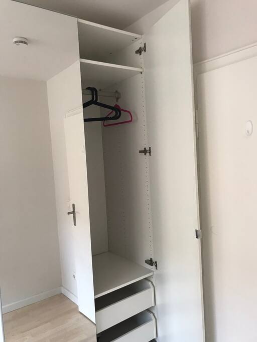 Wardrobe in guest room with hanger and shelf space for guests