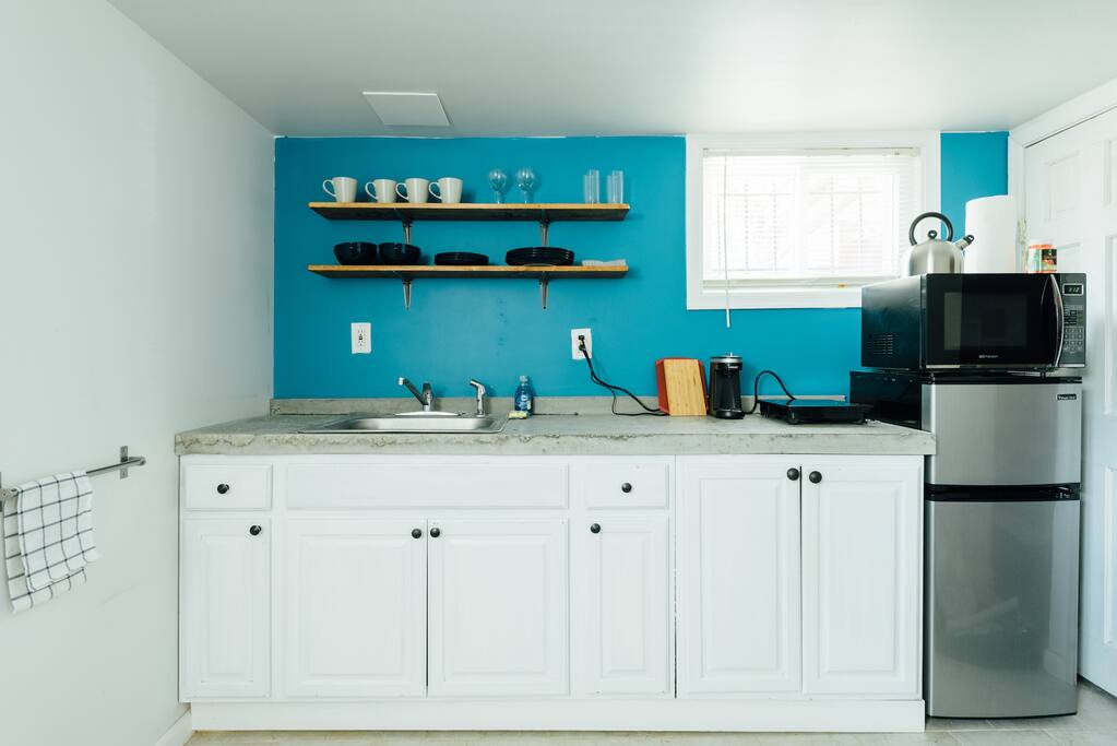 Kitchen with fridge, freezer, stove top, coffee machine