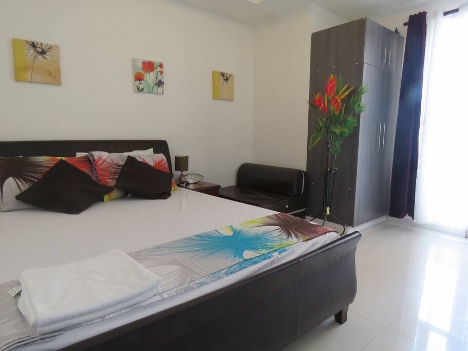 Bed with other type of cover and paintings