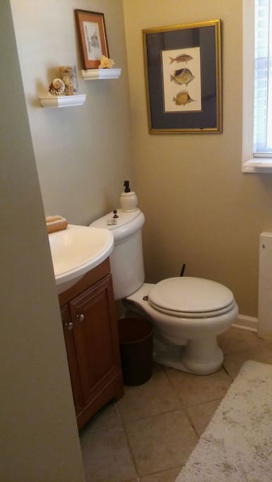 Hall bath with tiled shower.