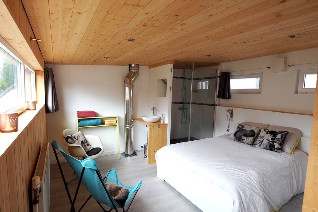 Chambre avec douche italienne et lavabo.
