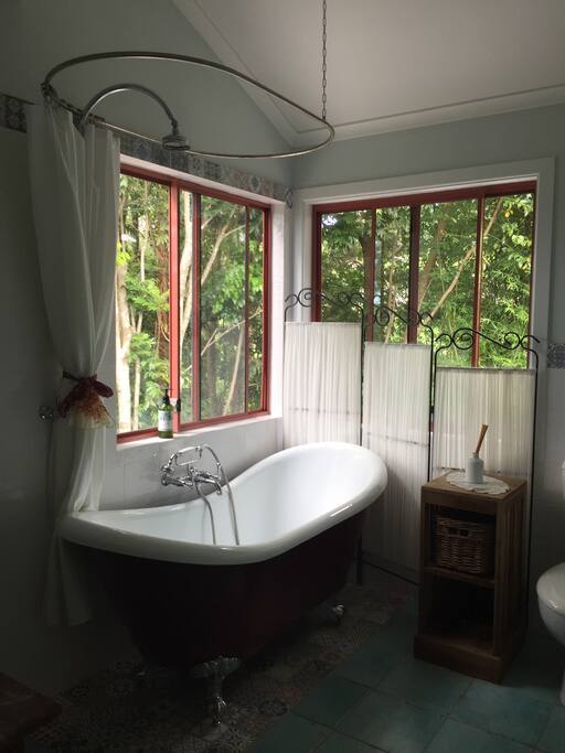 Luxurious claw foot bath with overhead shower, looks out on to rainforest, beautiful any time of day and so relaxing