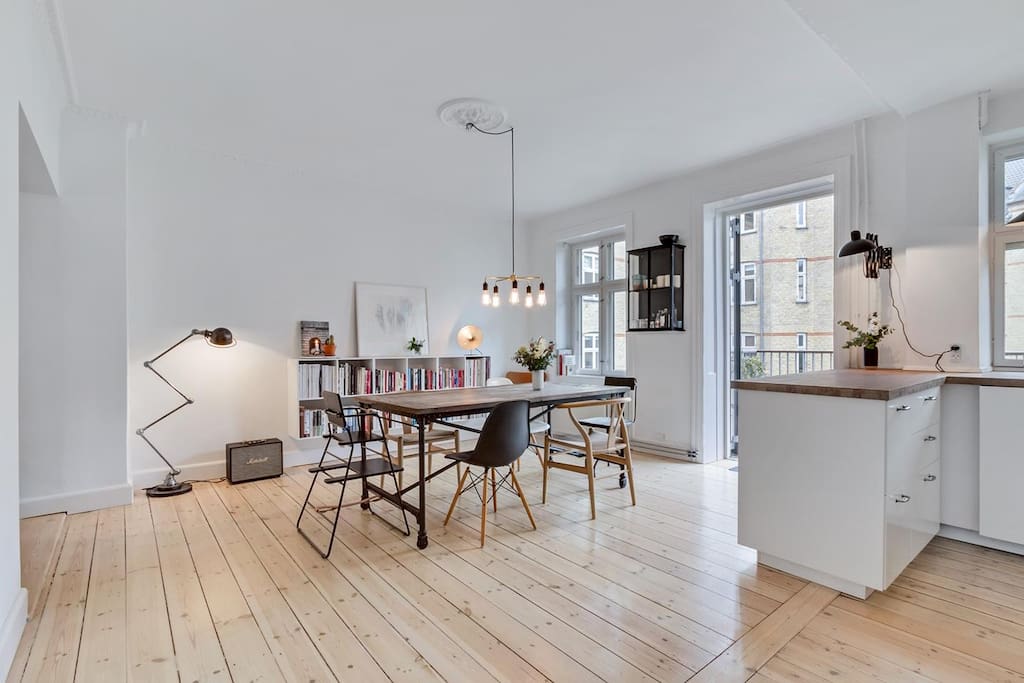 A spacious kitchen with a big fridge and rom for making delicious food