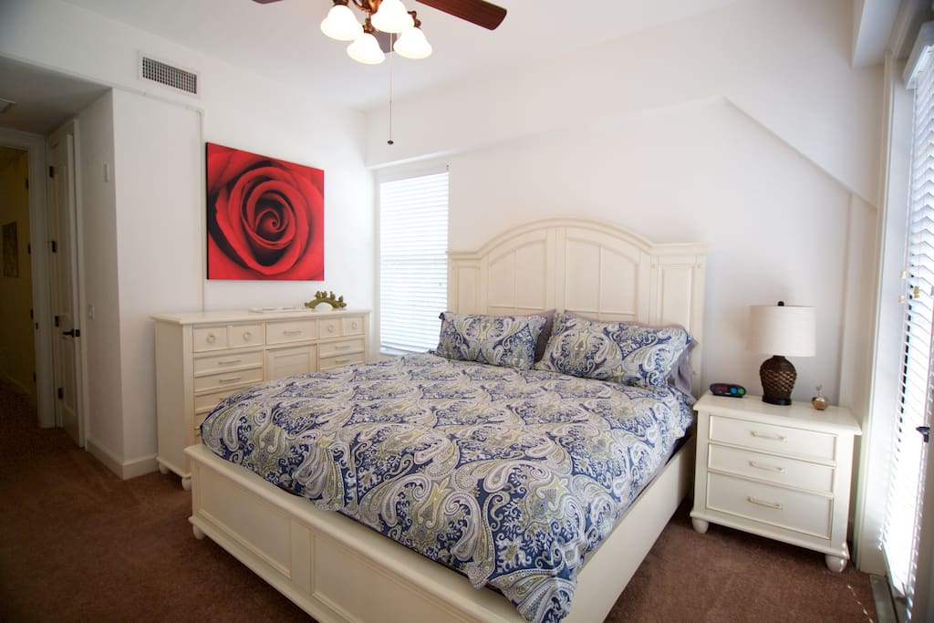 Master bedroom has a king bed and a balcony.