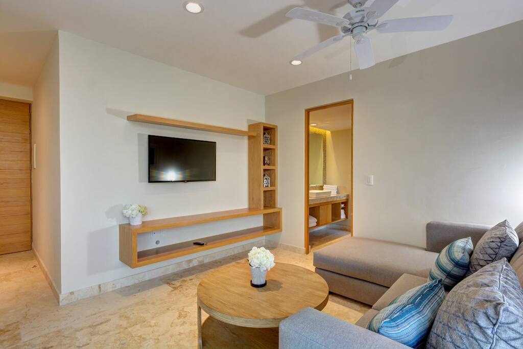 Large couch, flat-screen TV and cable
