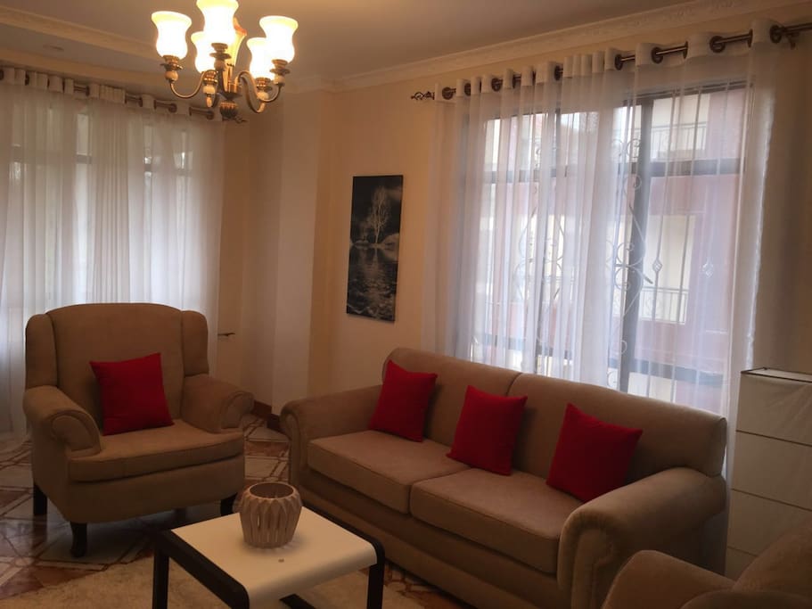 Spacious sitting/ dinning room space with big windows and ample lighting