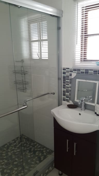 Neat bathroom with spacious shower.