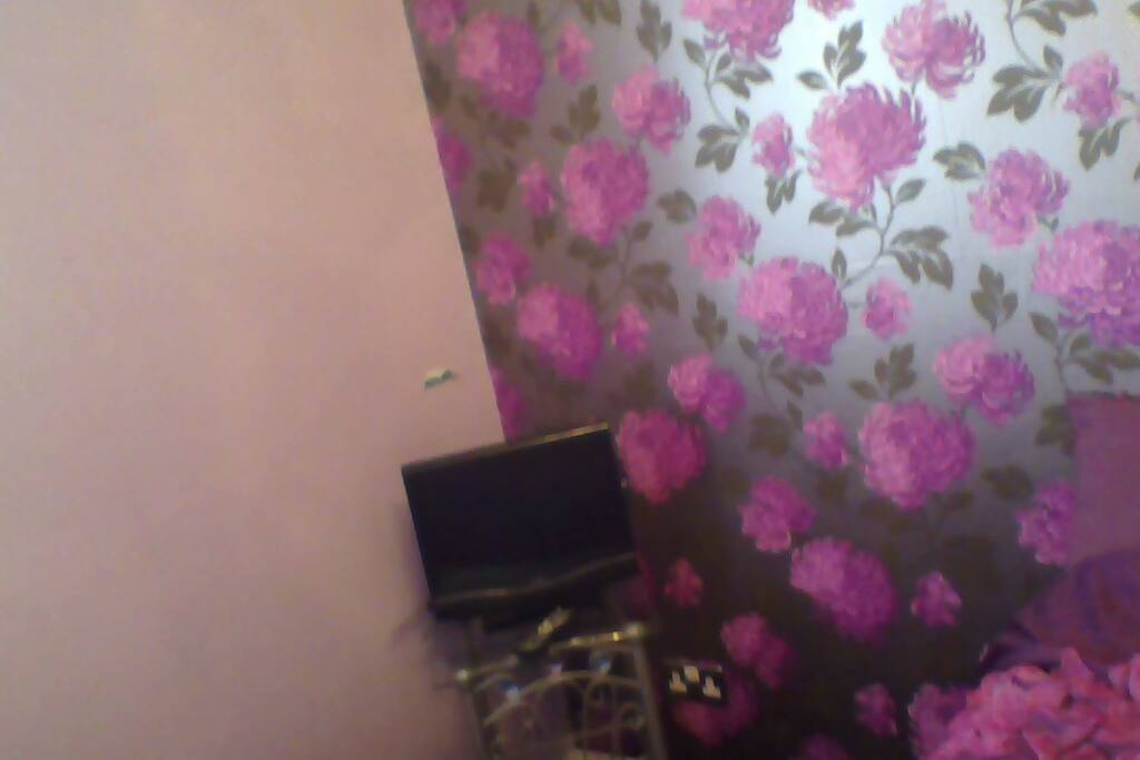 the room has a tv with dvd on the side of it