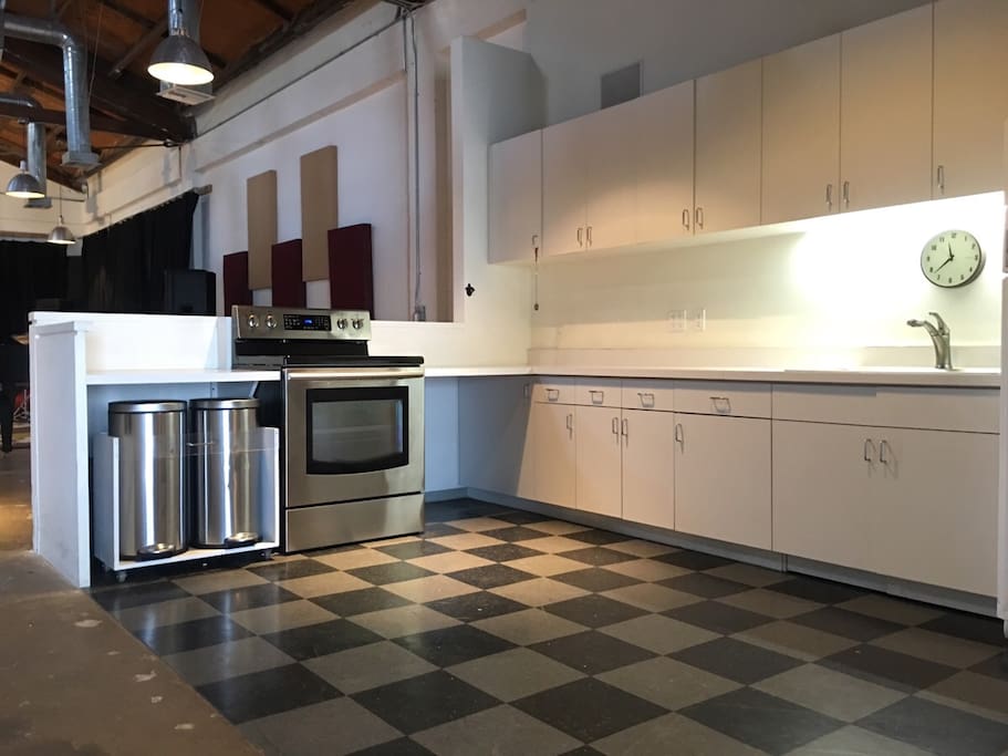 Full kitchen equipped with countertop stove, refrigerator/freezer, microwave, and additional appliances