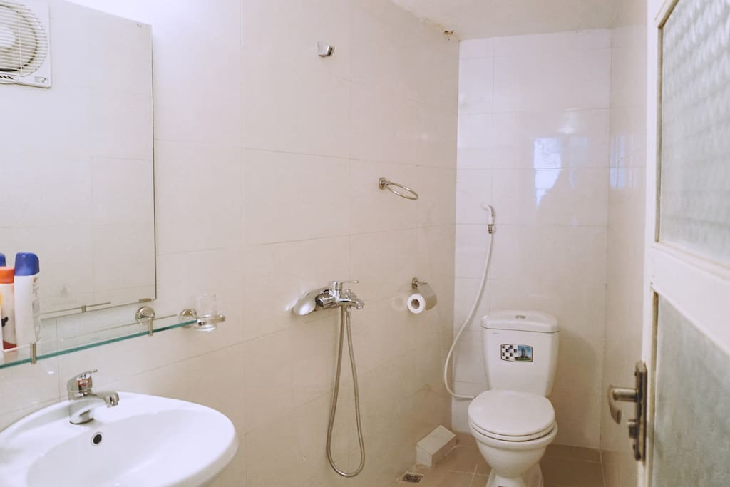Bathroom is bright and large.