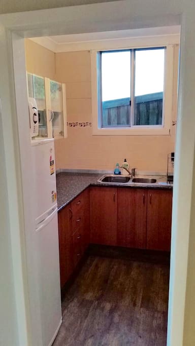 Kitchen with full size fridge microwave, coffee pod machine and basic cooking equipment ect