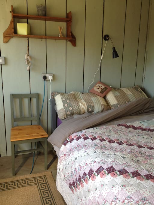 Comfy Double Bed topped with cosy quilts.