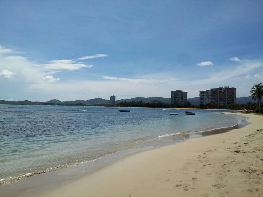 Tranquil beach in front of condo complex.