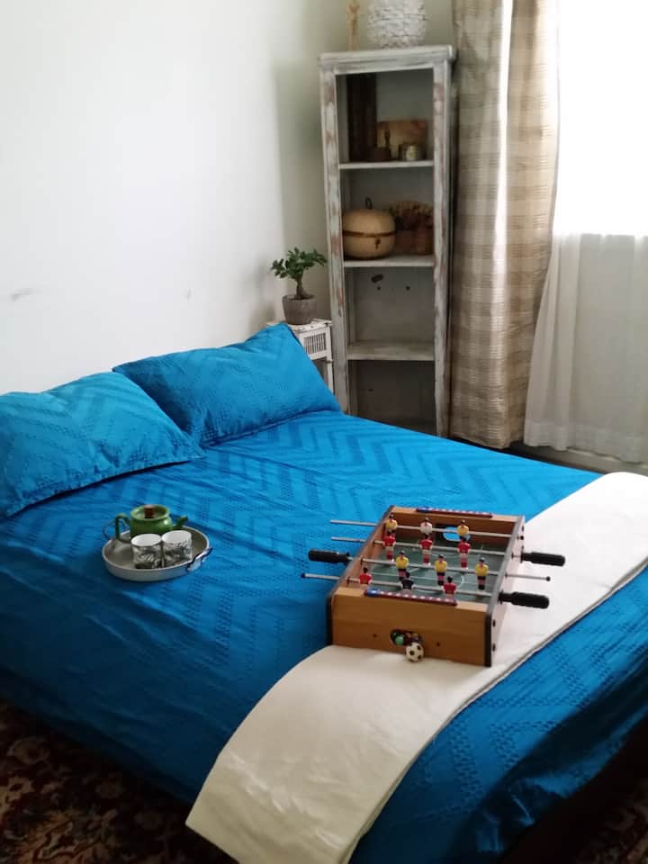 This room has a queen size futon with a mattress topper. Guests  have gone and purchased their own futon after an amazing night's sleep. 
Each of the two rooms available accommodate 2 adults.The topper can be used separately for kids.