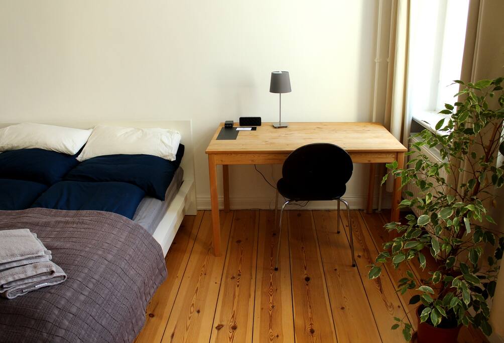 Desk with Bluetooth speaker and USB charging hub.