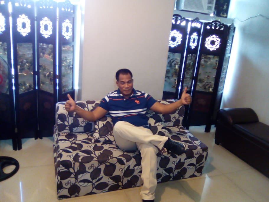 inside unit of my condo, with sofa bed, queen size. windows are covered with dividers, not curtains. windows facing the Araneta Center central part