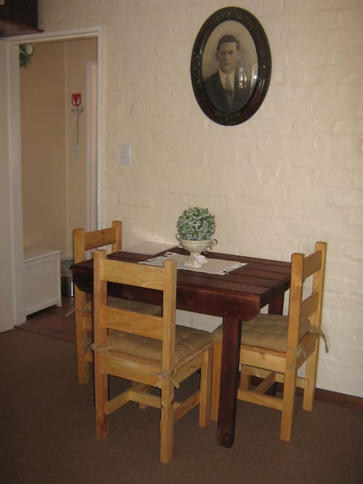 Dining/TV area has a table with four chairs where guests can enjoy their meals with a glass of wine or watch TV.