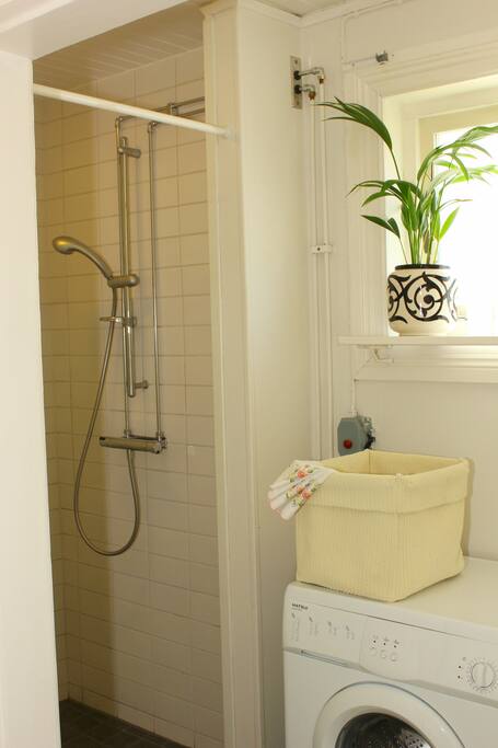 Bathroom with shower, tiled walls and floor