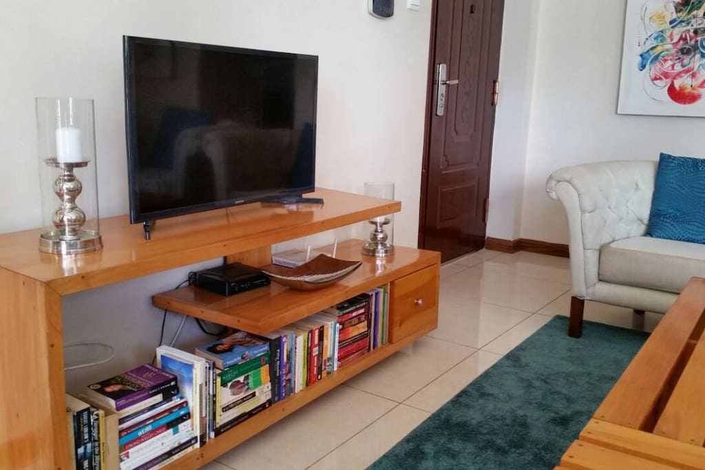 The TV stand which doubles up as the the book case holding our small library with books from different genres ranging from Biographies, self-help books, fiction and of course some law journals!