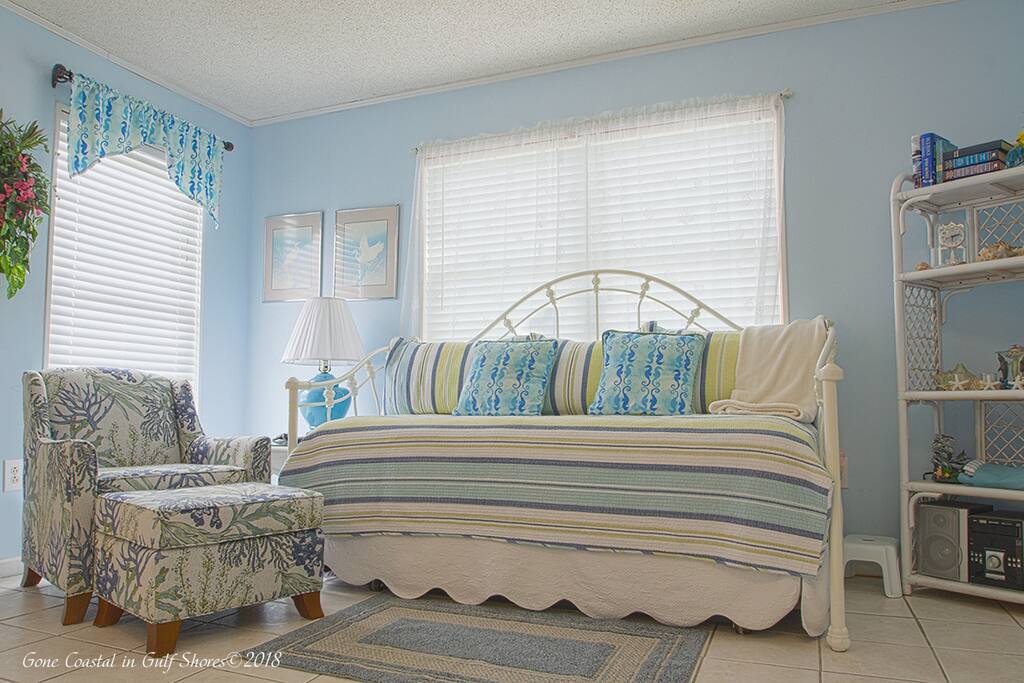 The living room features a daybed with trundle to sleep extra guests. The room is comfortable for watching TV or movies on the 32" screen.