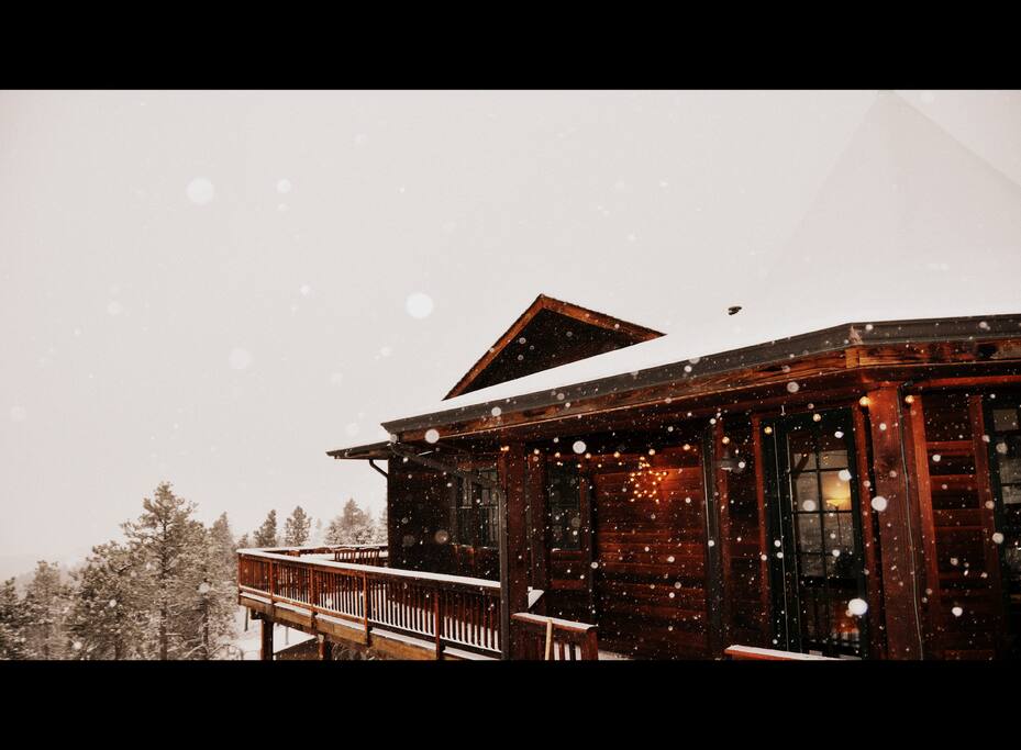 Main house with lights and snow, looking out over Sunshine Canyon.