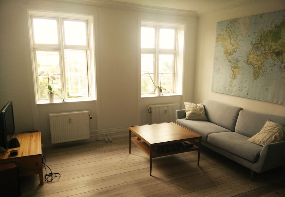 Spacious living room with big bright windows where you can relax on the couch and watch TV or listen to music on the stereo.