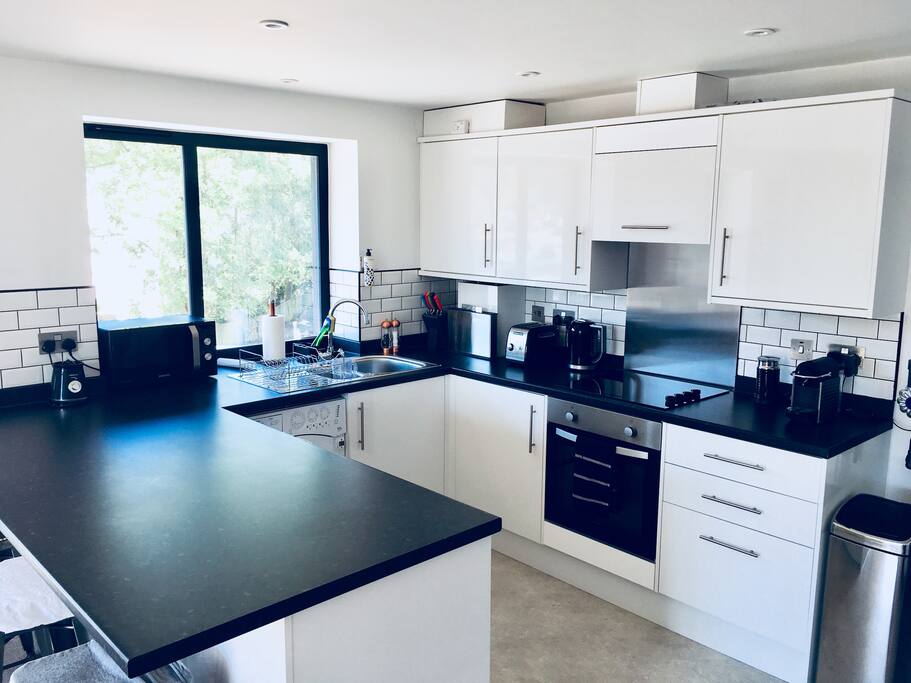 New fully equipped kitchen with blender, microwave, toaster, kettle, nespresso coffee machine and milk frother.