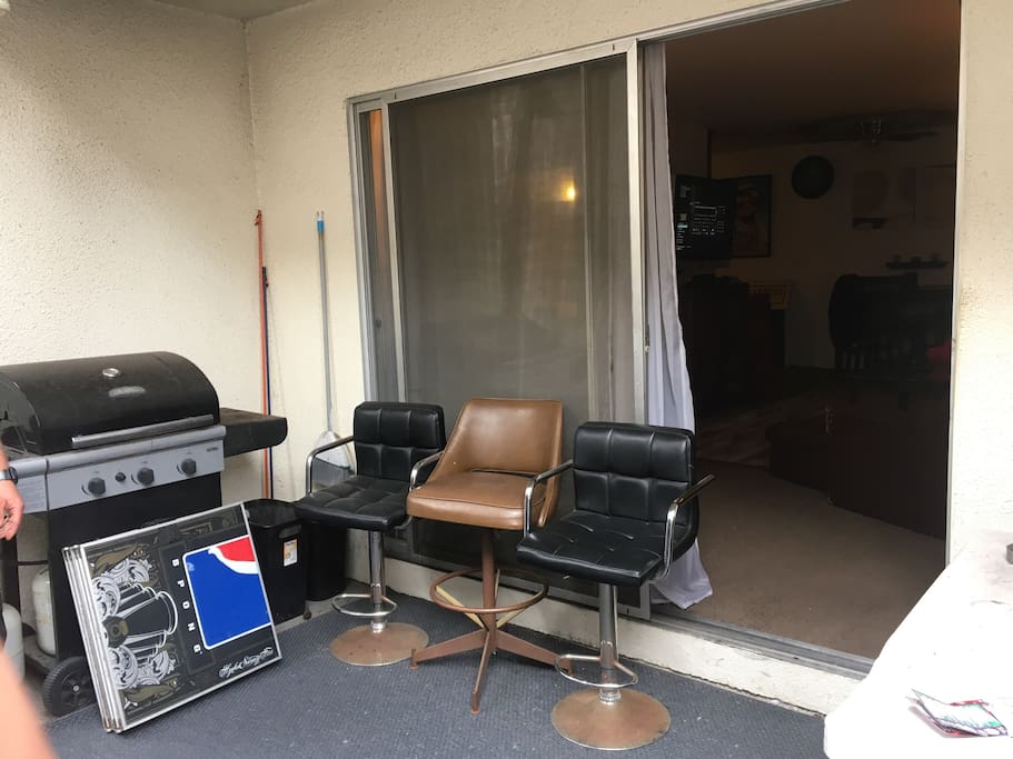 Large patio area with seating, BBQ, and smoking area.
