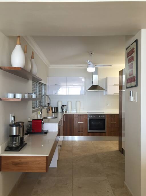 Modern kitchen with Double refrigerator ,automatic ice maker and cold filtered water. The nespresso machine or filter coffee maker leaves a choice for the coffee conneseur