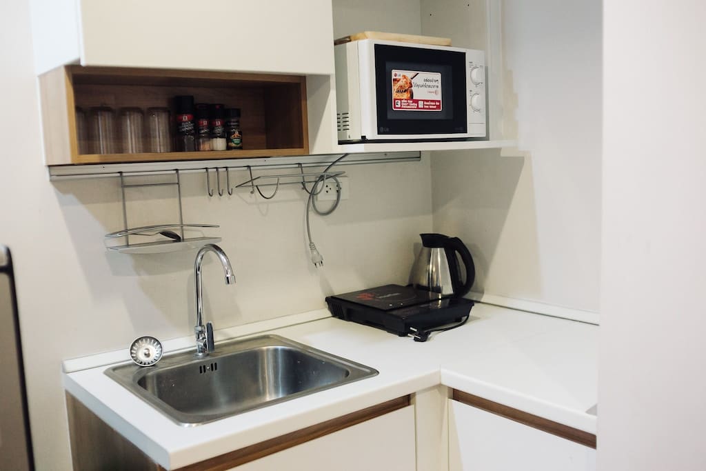There is a fully functional kitchen with a stove, microwave, rice cooker (located under the sink), Coffee pot, and dish rack to help you dry all your dishes.