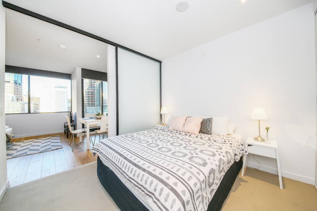 A bedroom with a Queen sized bed & plush pillows.