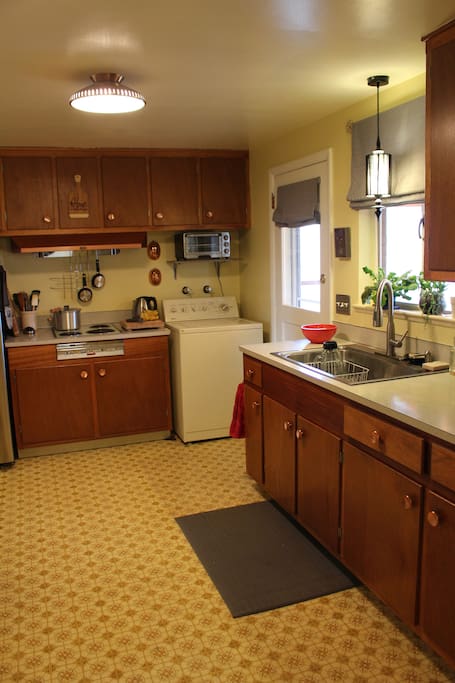 Kitchen is fully stocked with pots, pans, and basic cooking needs.