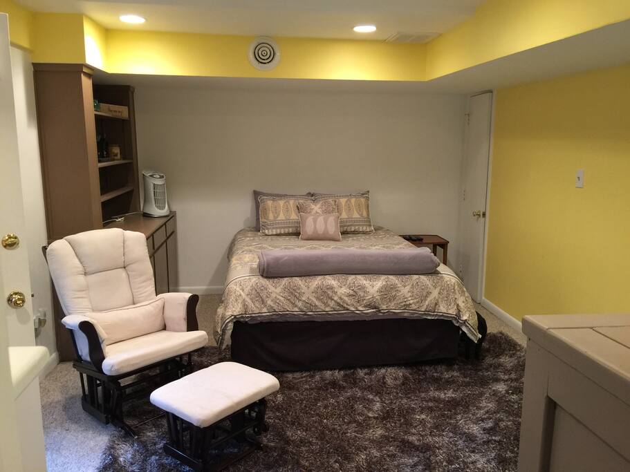 The bedroom. Soft shag rug, comfortable bed, and rocking chair.