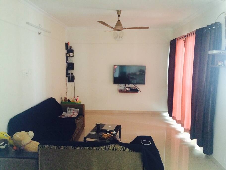 Spacious living room with sofa, internet & tv