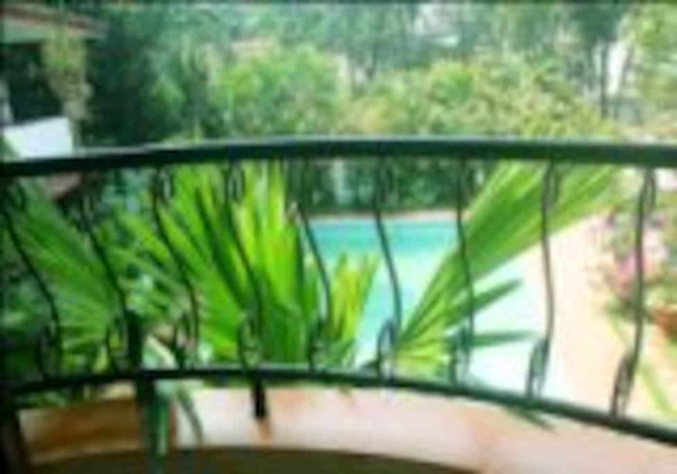 Balcony and kitchen area overlooks the pool