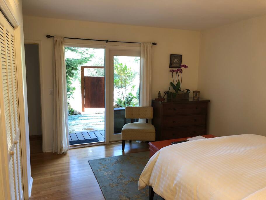 french doors open to private entrance and gate in front of parking spot