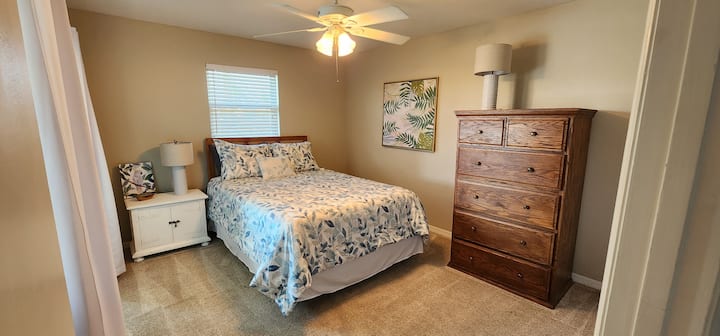 Relax in the comfort of the birds paradise room! You'll love the glass slider view to the pool and canalway