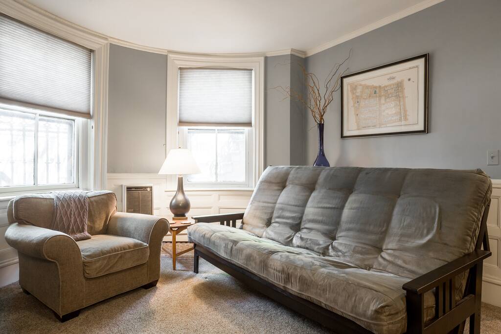 Two large windows in the living room provide natural light. Easy to lower cellular shades darken room when used as a bedroom. Two can sleep comfortably on this thick queen size futon.
