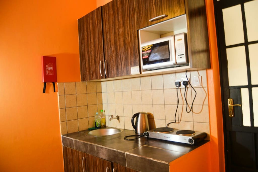 The kitchette area, inclusive of a cooker, kettle, microwave,pots and pans and culery. Plus a fridge