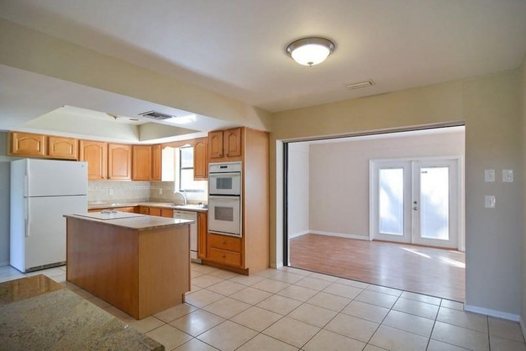 Kitchen leading to back living area.