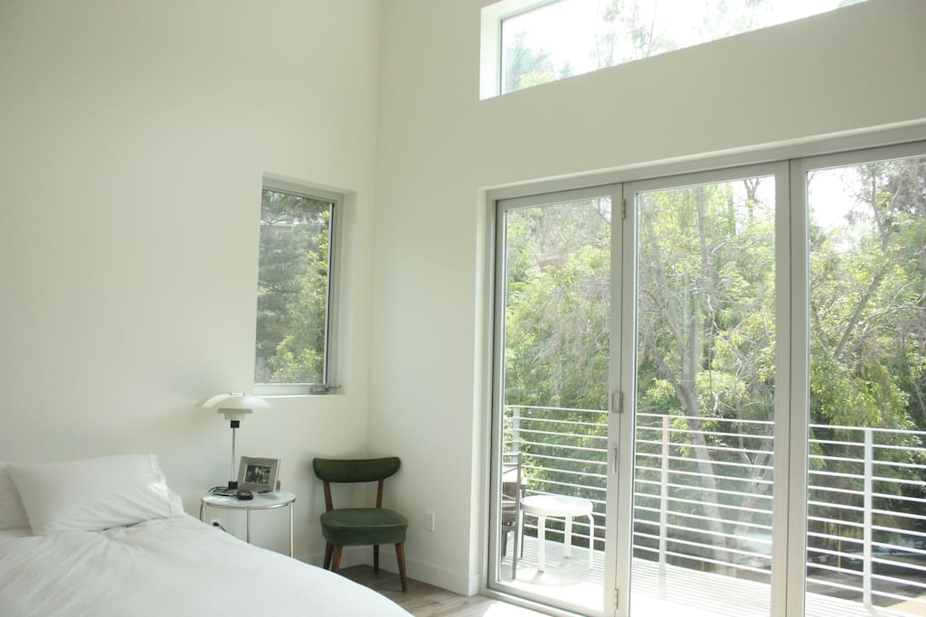 Master bedroom with full length windows to balcony.