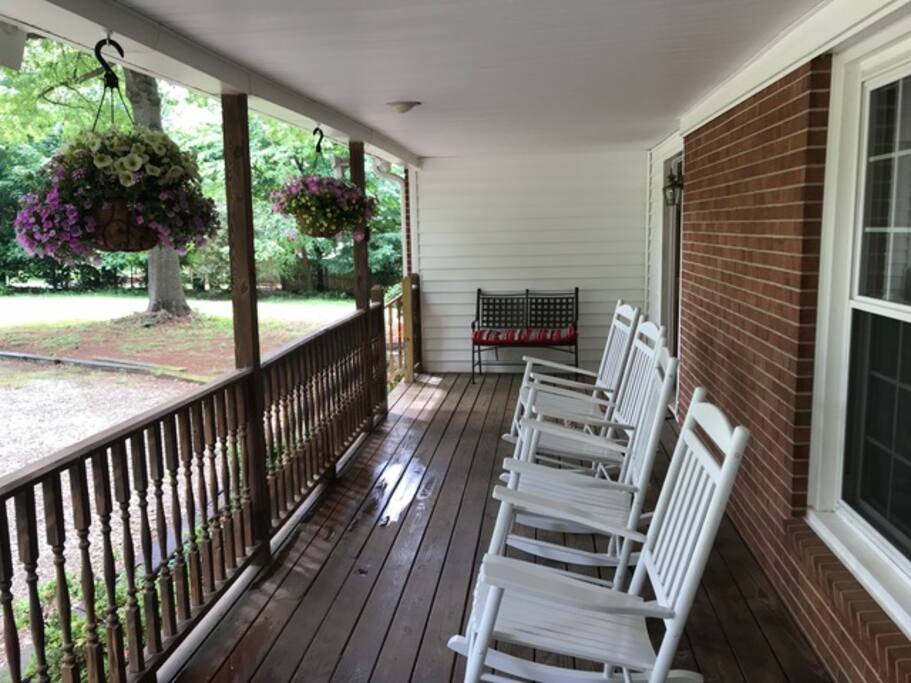Porch with garden bench and 4 rocking chairs; a perfect shady spot to relax!