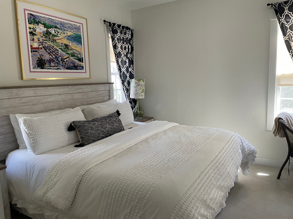 The Bedroom Suite includes a very comfy King Bed, a small work desk and a separate smart TV. 