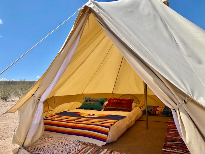 The Señor Doob campsite includes a spacious glamping tent with a queen bed made from heavy duty canvas material.