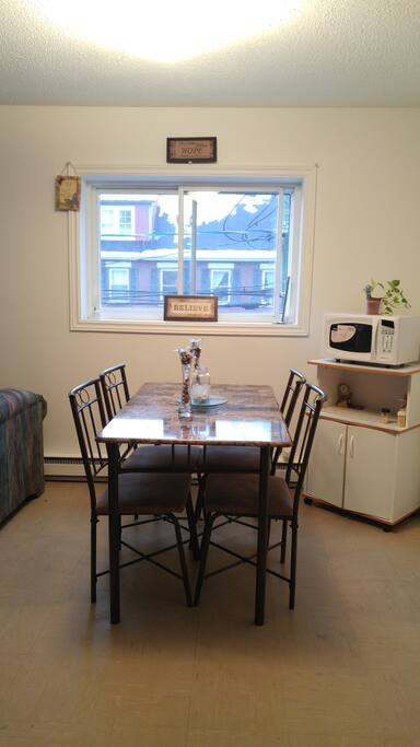 Dining room which includes a microwave and a microwave closet.