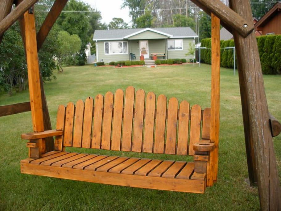Swing facing lake with home in background