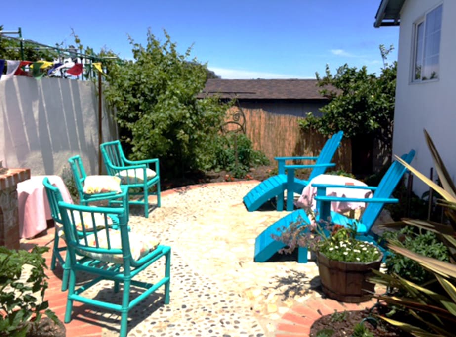 Backyard patio for your enjoyment, tomatoes growing and lots of fresh herbs