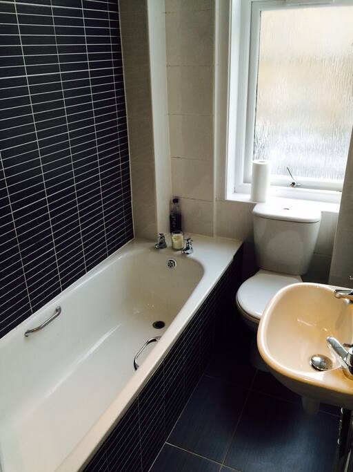 Bathroom with tub and electric shower